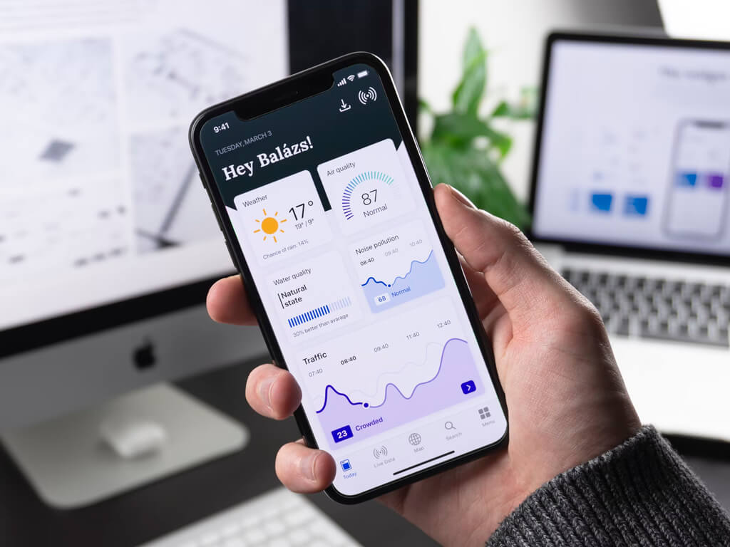 A smartwatch with a red band displaying the time